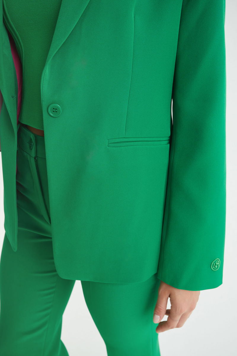 Blazer verde sastrero recto con hombreras, bolsillos ojal y pinzas en frente y espalda. 
