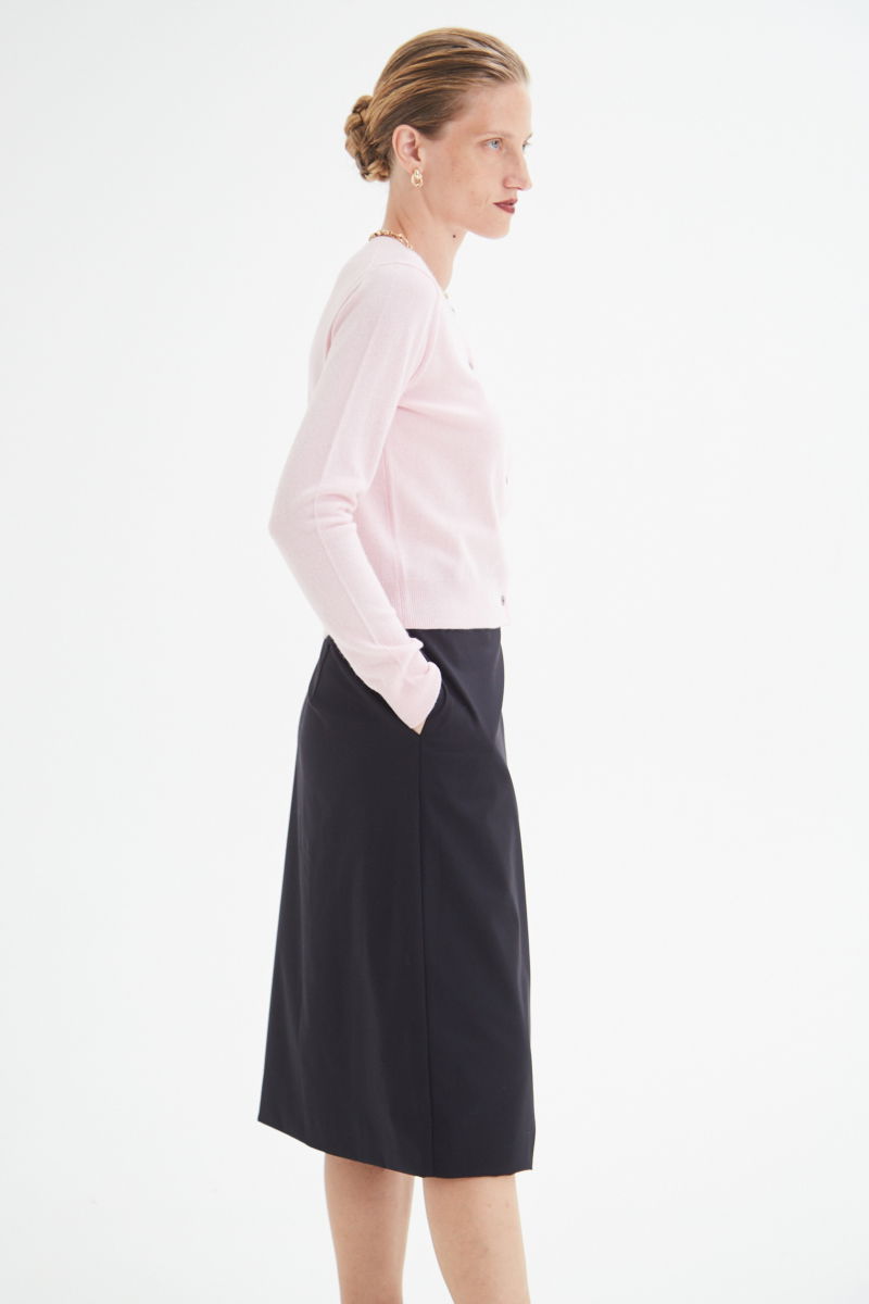 Cardigan rosa de lana y cachemira de corte recto entallado en la cintura con terminaciones en rib en puños y ruedo, cuello redondo cerrado y botones a tono.