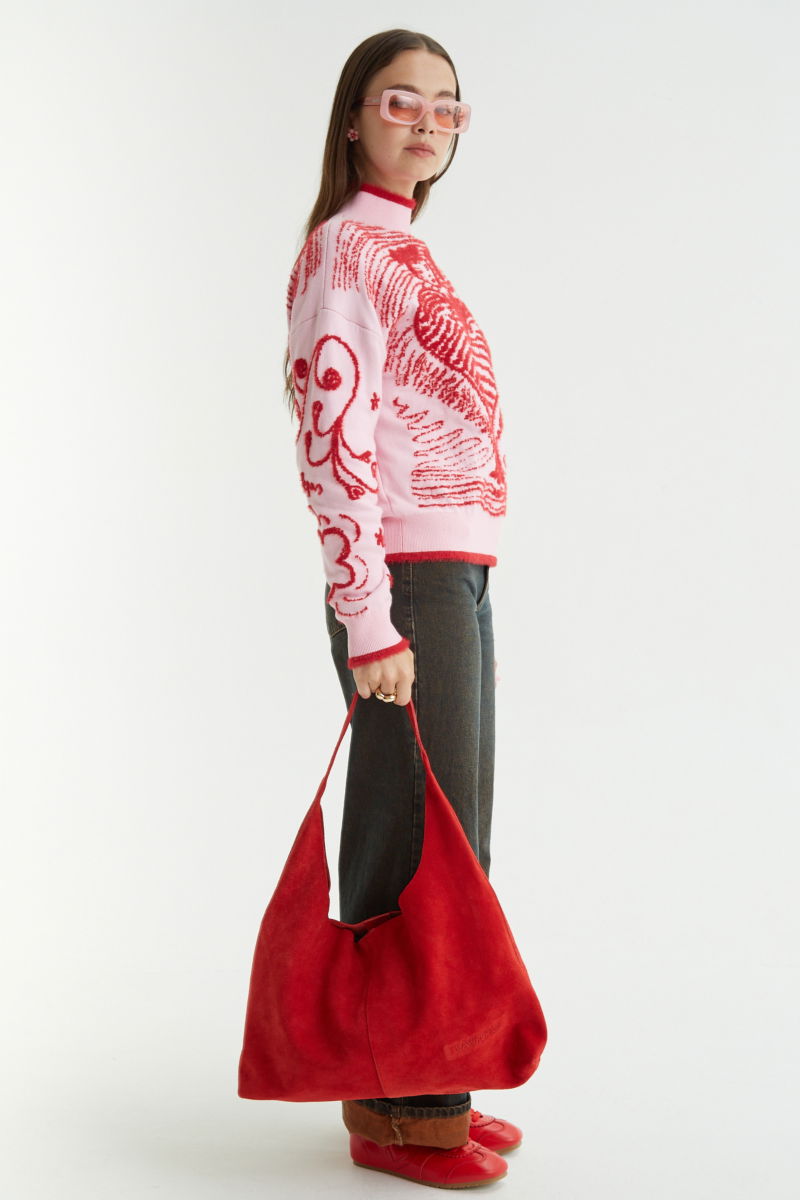 Maxi cartera roja de gamuza con broche con imán, logo de Las Pepas en el frente y bolso interno de red desmontable. 