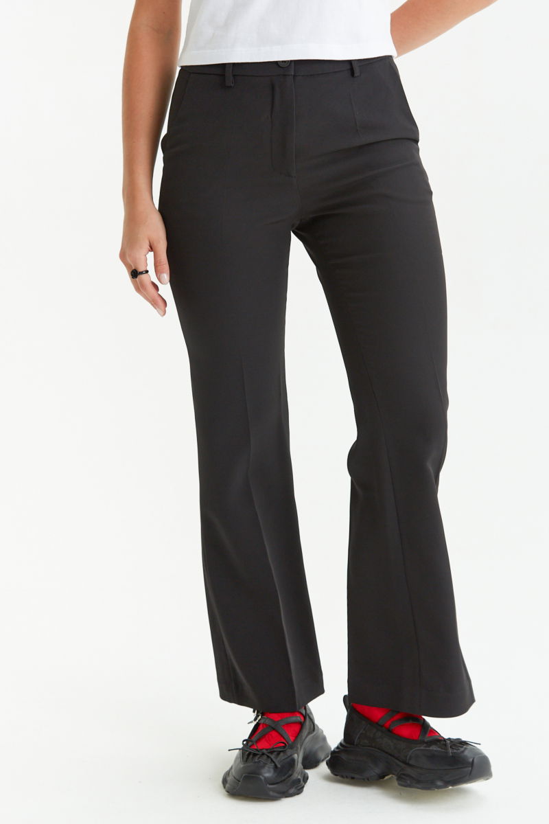 Pantalón negro sastrero tiro alto de corte recto y largo al tobillo con pinzas en el frente, bolsillos laterales y bolsillo ojal en la espalda. 
