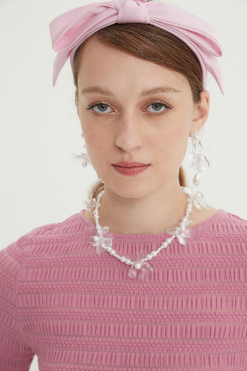 Remera rosa al cuerpo con mangas semi acampanadas, con escote a la base del cuello y textura fruncida. 
