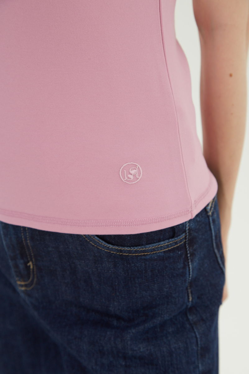 Remera rosa básica al cuerpo larga a la cadera con escote redondo y mangas cortas raglan. 
